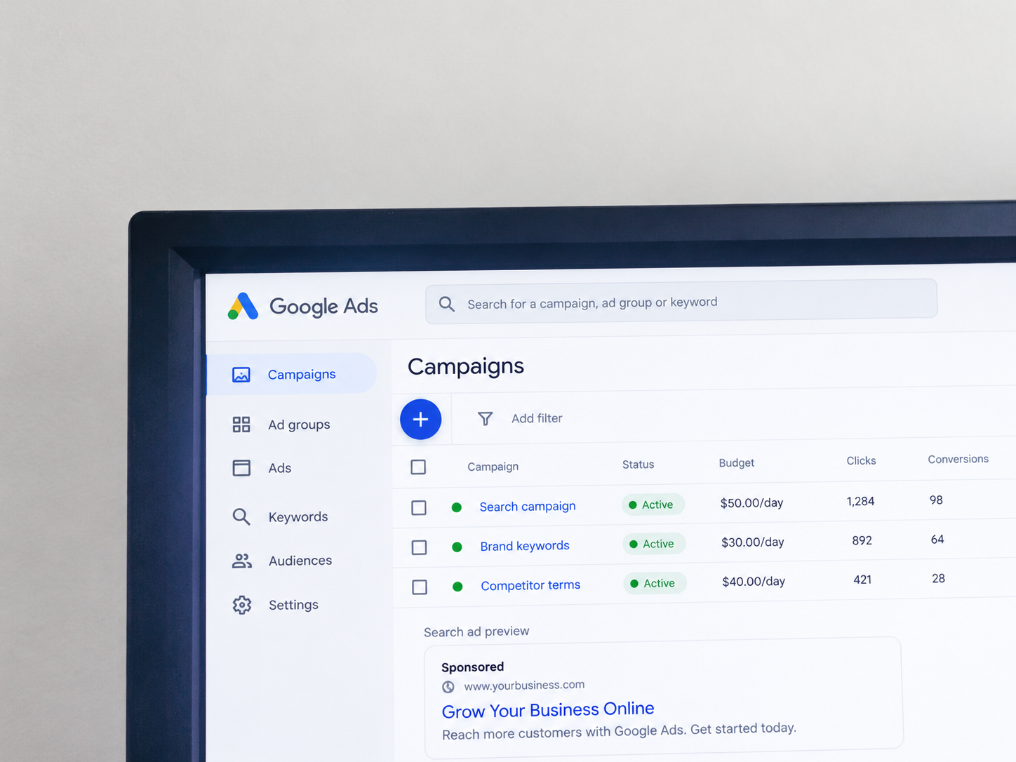 Monitor displaying paid advertising campaigns and a search ad preview